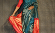 Indian model wearing an elegant and ornate saree (sari) during a South Asian bridal fashio...