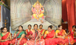 Tamil Hindu women sing devotional Carnatic songs as Hindu priests perform a special abhish...