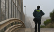 A member of the Civil Guard observing the border fence at the Morocco–Spain border in the...