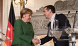 Angela Merkel, Germany's chancellor, left, shakes hands with Alexis Tsipras, Greece's Prim...