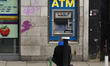 A beggar seats outside an ATM machine in Dublin City Center. On Friday, January 18, 2019,...