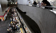 A woman observes the crowded platform of a subway station during rush hour in Sao Paulo, B...