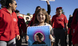 A child and striking teachers with the Los Angeles Unified School District march in a para...