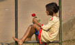 DHAKA, BANGLADESH - JANUARY 22 : A flower girl (flower seller) passes her idle time inside...