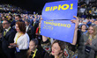 A supporter holds placards vreading " I trust! Yulia Tymoshenko 2019", during a solemn con...