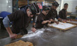Palestinians work at candy factory in Gaza City on January 22, 2019. 