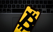 The Bitcoin logo is seen on a portable mobile device in this photo illustration on January...