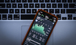 A graph displaying the Apple stock price is seen on the Stocks market application in this...
