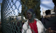 Migrants wait to leave Castelnuovo di Porto migrants center, some 10 kilometers north of R...