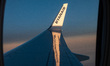 Wing view from the window of an airliner during the magic hour after the sunset. The aircr...
