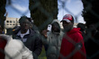 Italy, Rome: Migrants show their residency permit to the press as they wait  to leave Cast...