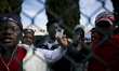 Italy, Rome: Migrants show their residency permit to the press as they wait  to leave Cast...
