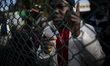Italy, Rome: A migrant shows his residency permit to the press as he waits  to leave Caste...