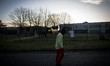 Italy, Rome: A migrant walks next to the fence of Castelnuovo di Porto migrants center, so...