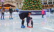 Ice skating rink in London during Christmas time, with decoration in the mood. Evening out...