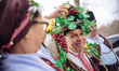 Bulgarians pours a vine with a red wine as dressed with national traditional clothes peopl...