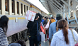 Passengers walk with luggage at Hua Lamphong Station in Bangkok, Thailand on December 30,...
