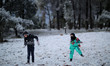 A Palestinian boy hurls a snowball fight during snowy weather in the West Bank city of Nab...