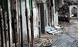 Child looking out the door of his house destroyed in Shijia neighborhood during rainfall,...