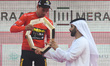 Sheikh Mansour Bin Mohammed Bin Rashid Al Maktoum handing a UAE Tour Trophy to Primoz Rogl...
