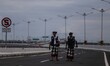 Balinese traditional guards, or pecalang, patrol a highway during the observation of Nyepi...