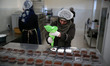  Palestinian women cooking desserts at Bent Areef Cooperative Society for Food Processing...