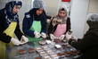  Palestinian women cooking desserts at Bent Areef Cooperative Society for Food Processing...