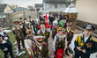 Koliadnyky - group of adult and kids dressed in costumes of soldiers and traditional Ukrai...
