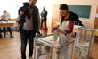 A woman casts a ballot at a polling station during Ukrainian presidential elections in Kie...