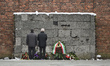 People pay their respect in front of the Wall of Death, in the former Auschwitz  amp, ahea...