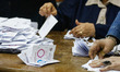Election workers count ballots at the end of three-day vote of the referendum on constitut...