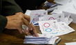 Election workers count ballots at the end of three-day vote of the referendum on constitut...