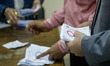 Election workers count ballots at the end of three-day vote of the referendum on constitut...
