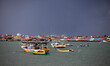 Palestinian Territory - Fishing boats are seen anchored as a huge wave crashes over a sea...
