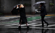 Women walk with umbrellas in Buenos Aires, Argentina, on June 16, 2019. 