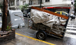 A man cart selling cardboard secured to a grate during a massive power blackout on June 1...