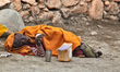 Elderly woman afflicted with leprosy begs along the roadside in Choglamsar, Ladakh, Jammu...