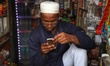 A shopkeeper uses his mobile phone inside his shop in New Delhi, India, on 7 July 2019. 
