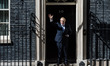 Boris Johnson waves as he enters 10 Downing Street for the first time as the new Prime Min...