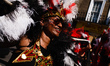 Paraders in feathered costumes make their way along Chepstow Road on the second and final...