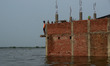 Indian local residents of flood affected area shift on the roof of their houses as after t...