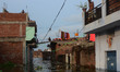Indian local residents of flood affected area shift on the roof of their houses as after t...