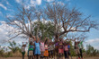 Children make impressions of a baobab tree in Malawi's Manchinga district on 17 June 2017....