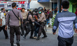 A protester is taken away by police outside Regional People's Representative Assembly Mage...