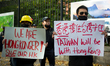 Demonstrators holding placards are seen during a rally against Chinese government  on Sept...