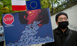 A demonstrator is seen holding a placard during a rally against Chinese Government on Sept...