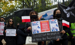 Demonstrators holding placards are seen during a rally against Chinese government  on Sept...