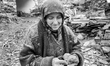 (EDITOR'S NOTE: This image has been converted to black and white.) An elderly woman walks...