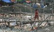 Children cross a bamboo bridge in a slum on the coast, Cilincing, Jakarta on November, 21,...