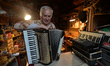 Former theatre actor and long time artist and luthier, Jozef Gmyrek (age 71), tunes an acc...